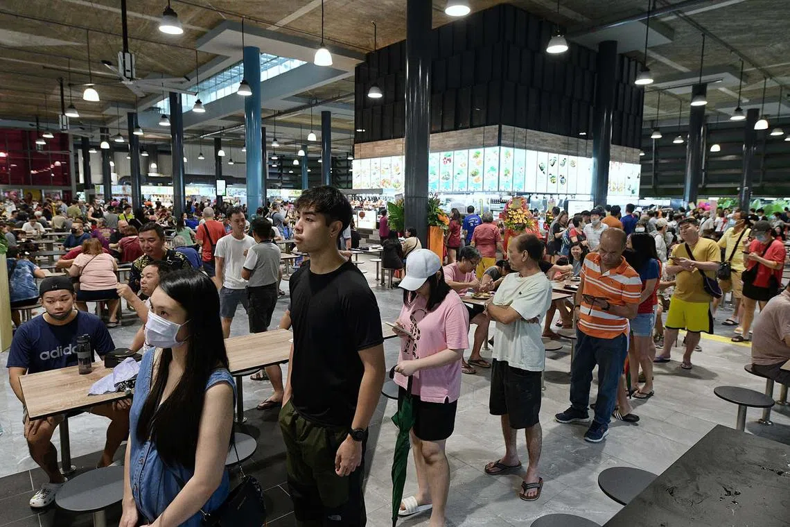 Customers flooding Senja Hawker Centre on its opening day on Dec 11, 2022. The snaking queues meant some had to wait about 30 minutes for their food. There are 28 stalls in the social enterprise hawker centre, including four that have a Michelin rating – awarded to eateries recognised for serving good food.