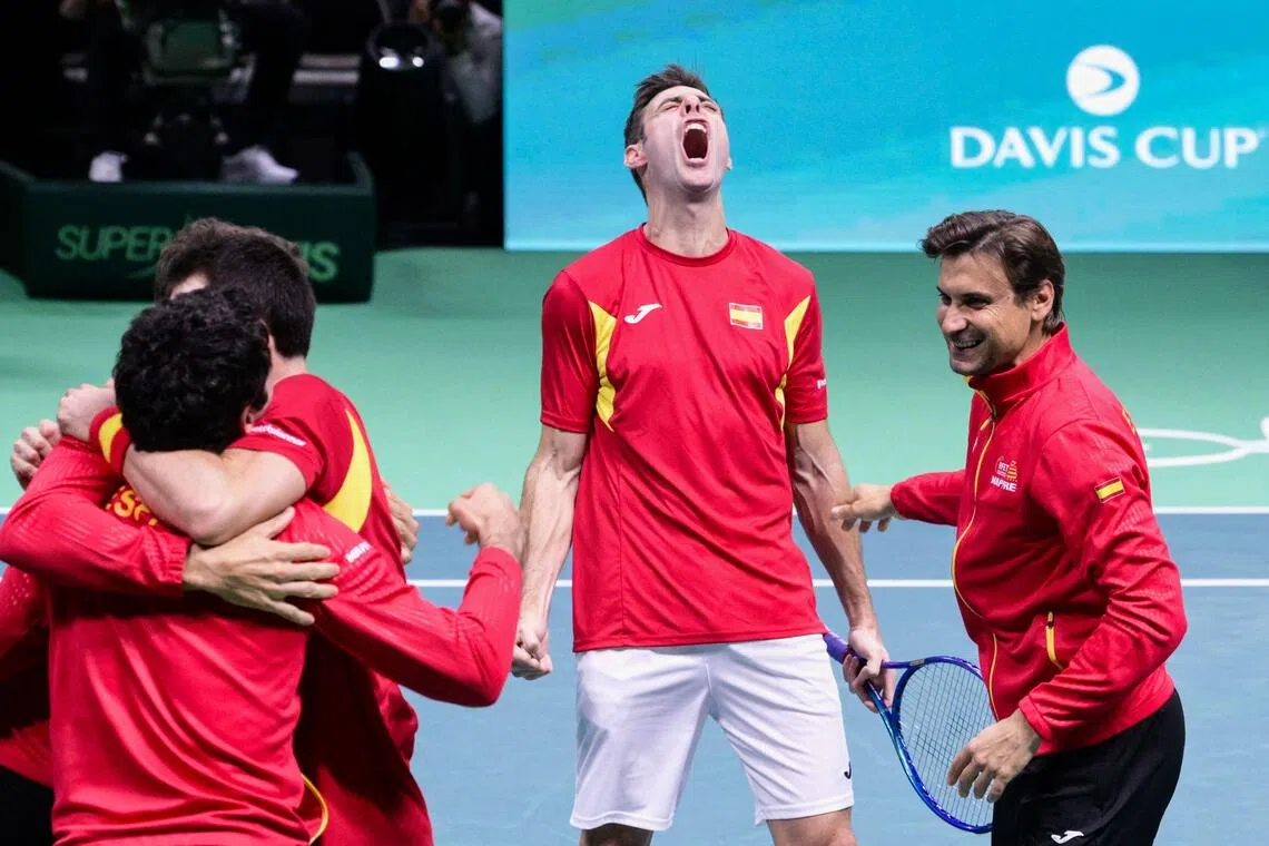Spain's Pedro Martinez Portero (centre) celebrating Spain's victory next to teammates and captain David Ferrer (right) at the end of the 2-1 Davis Cup semi-final win over Germany at the Super Tennis Arena in Bologna on Nov 22, 2025.