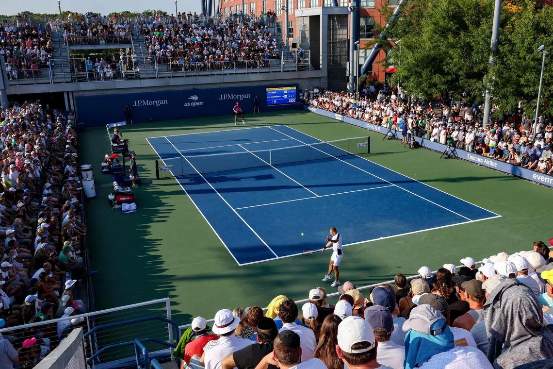 Daniel Evans of Britain returns against Karen Khachanov of Russia during their long US Open first-round battle.