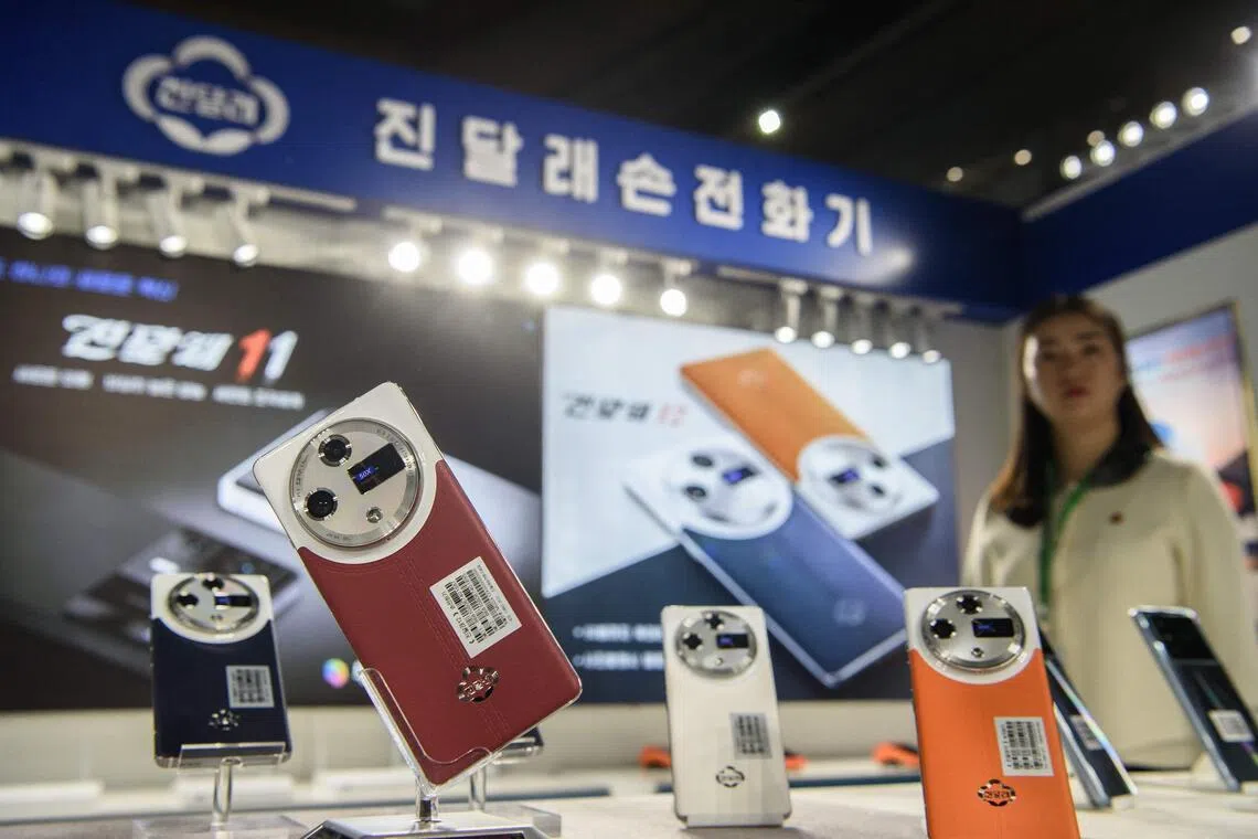 Domestically produced Jindallae mobile phones are displayed at a stall during the 24th Pyongyang Spring International Trade Fair opening at the Central Youth Hall in Pyongyang on May 4. 