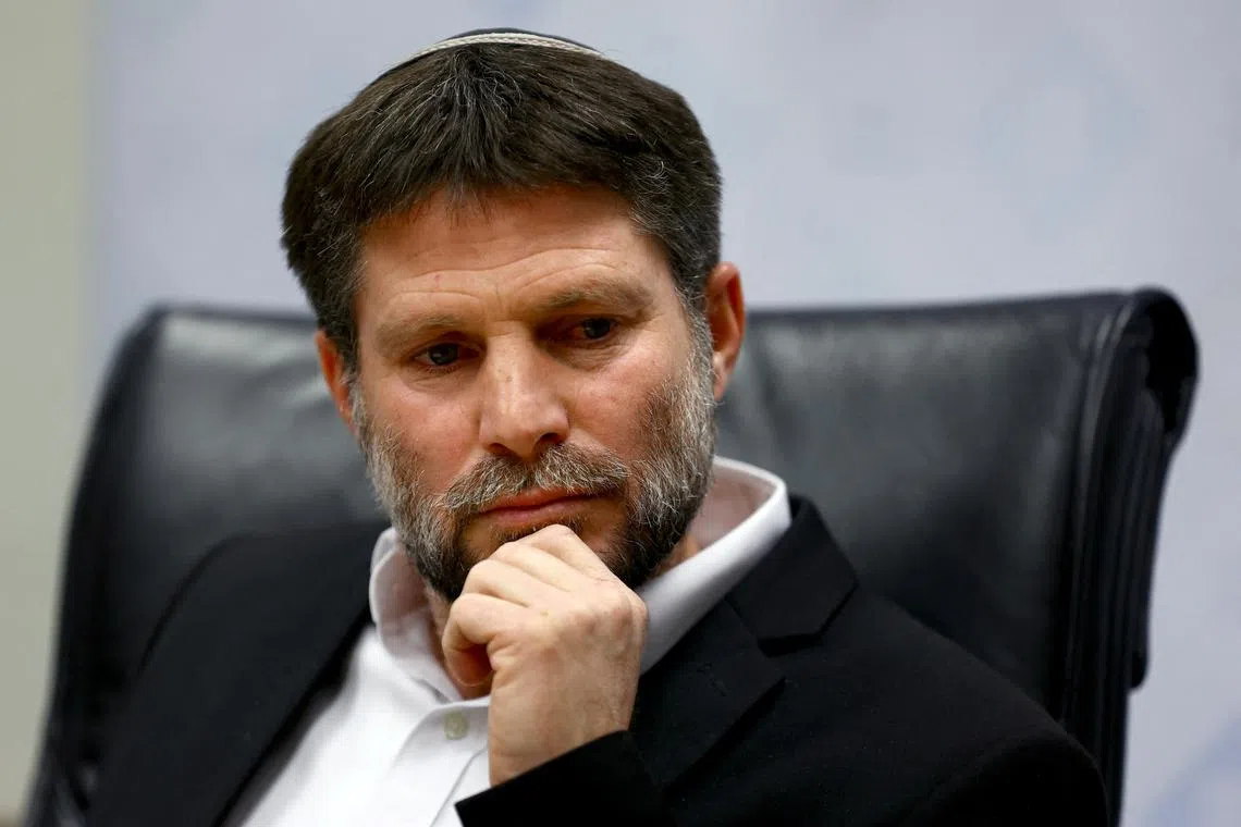 FILE PHOTO: Israeli Finance Minister Bezalel Smotrich attends a news conference after announcing that he will sign an order to seize Palestinian Authority funds and transfer them to the families of victims of Palestinian attacks, at Israel's Finance Ministry in Jerusalem, January 8, 2023. REUTERS/Ronen Zvulun/File Photo