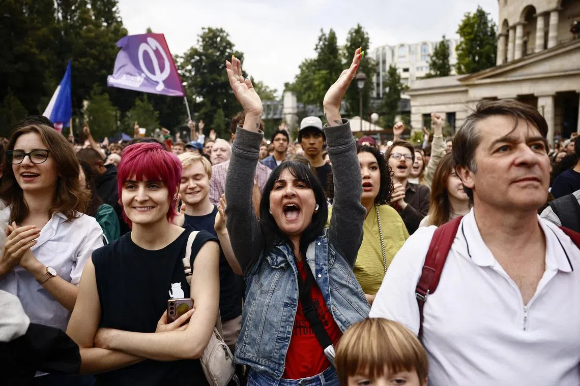 Supporters of French far-left opposition party La France Insoumise (France Unbowed - LFI) gather at Place Stalingrad before partial results in the second round of the early French parliamentary elections in Paris, France, July 7, 2024. REUTERS/Yara Nardi