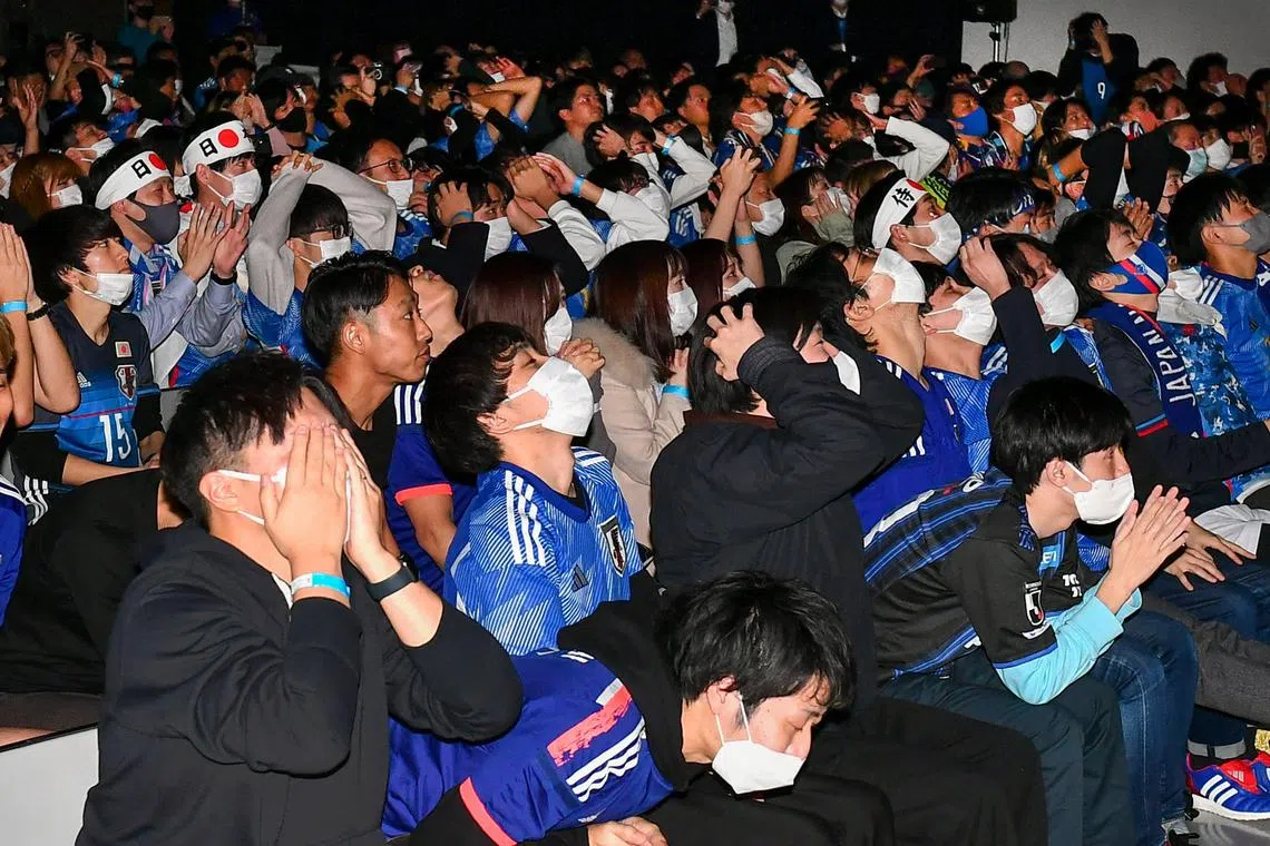 Japan fans reacting during a televised broadcast of the last-16 match against Croatia at a public viewing area in Tokyo in the wee hours of Tuesday. 