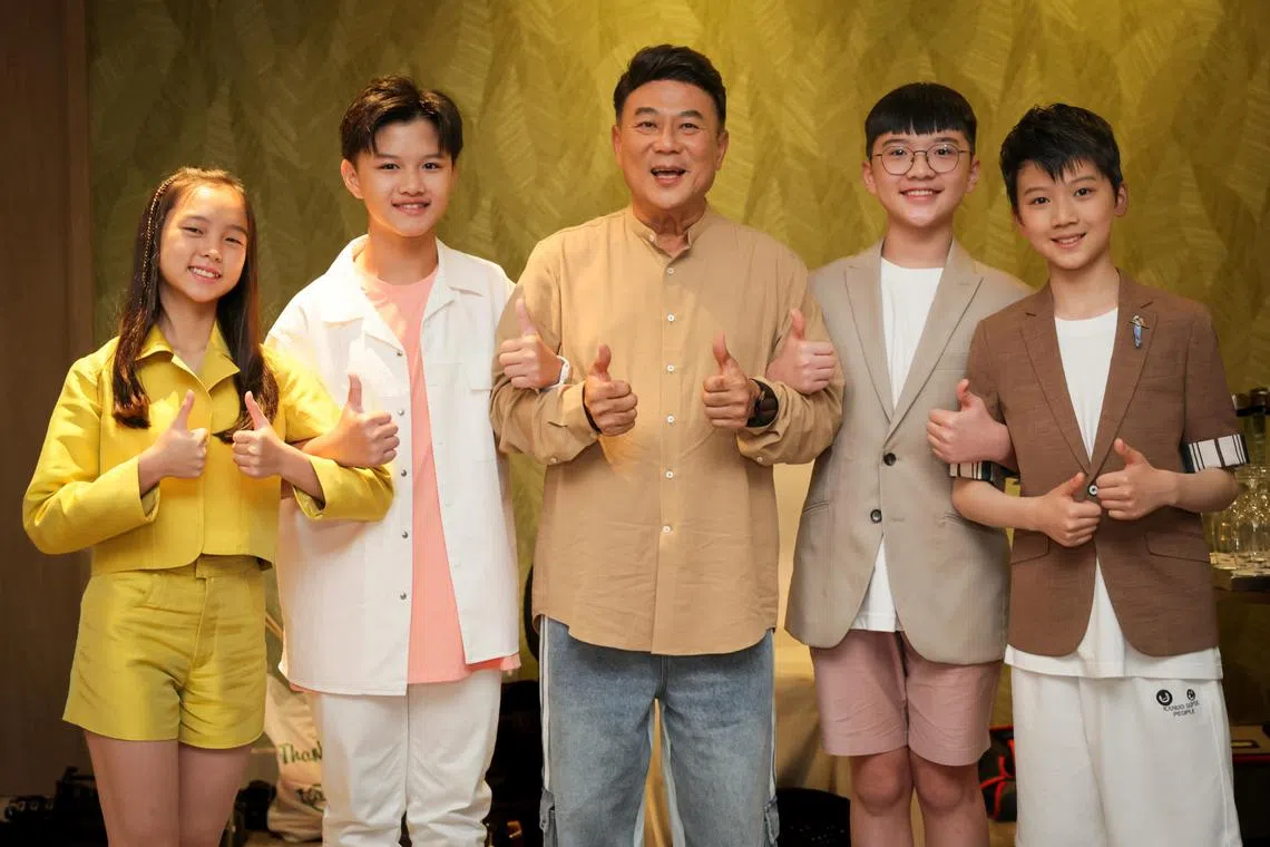 Jack Neo (centre) recruits young actors Goh Wee-Ann (left), Camans Kong, Joseph Ng and Zhou Yuchen to play a group of Primary 6 students in I Not Stupid 3. 