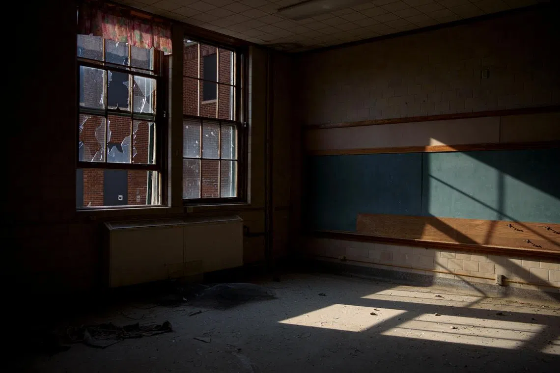 FILE PHOTO: Sunlight shines through broken windows in an abandoned building that used to be part of the former St. Paul’s Indian Mission School in Marty, South Dakota, U.S., September 11, 2021. REUTERS/Callaghan O'Hare/File Photo
