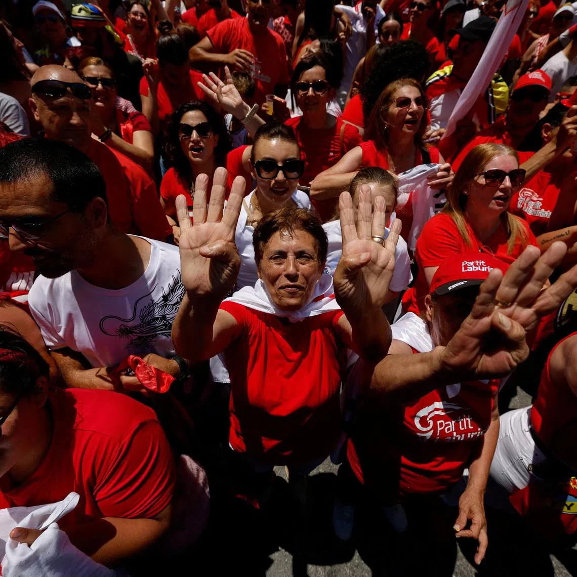 Supporters of Malta's Labour Party show four fingers, representing a record-breaking fourth consecutive term in power, amid celebrations as the party has claimed victory in the general election, outside the party headquarters in Hamrun, Malta May 31, 2026.  REUTERS/Darrin Zammit Lupi