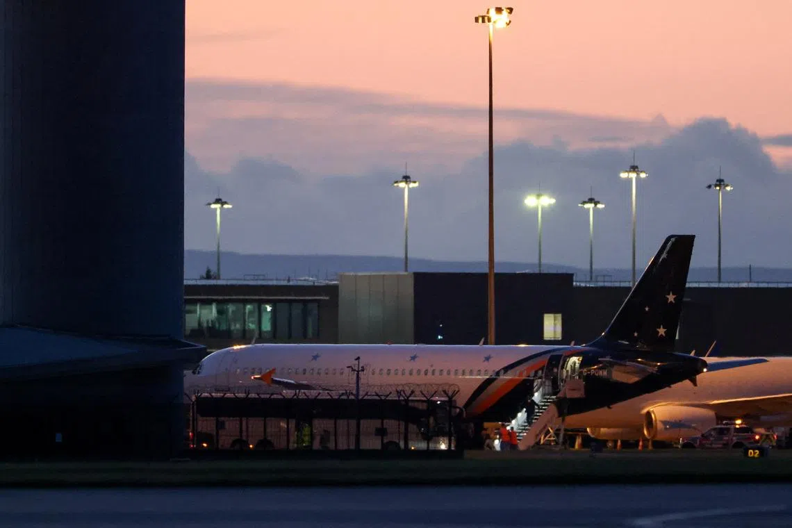 A repatriated British national from the cruise ship MV Hondius, which was affected by a hantavirus outbreak, disembarks a plane at Manchester Airport in Manchester, Britain, May 10, 2026. REUTERS/Phil Noble