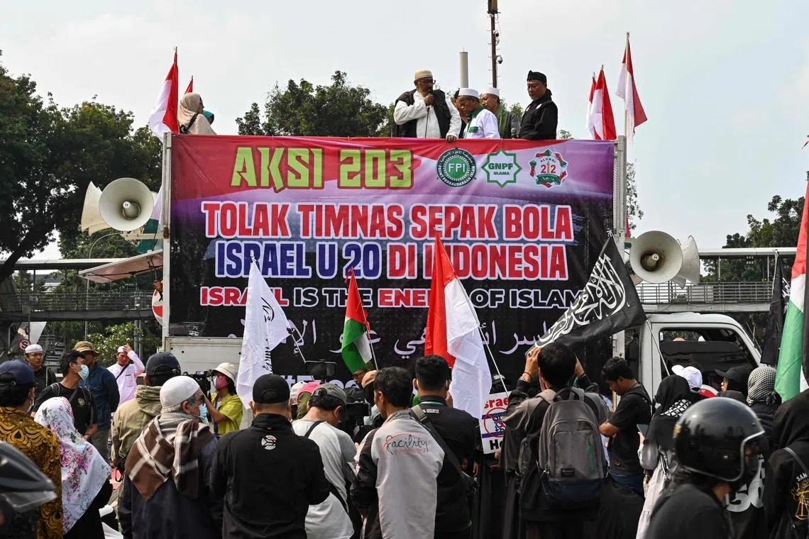 Indonesians take part in a rally to reject the participation of Israel's team in the FIFA U-20 World Cup, in Jakarta, on March 20.