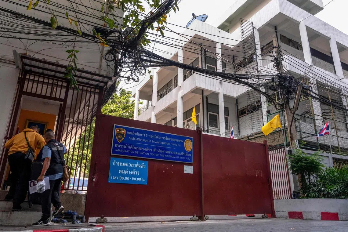 Police enter an immigration detention centre in Bangkok.