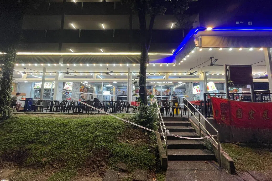 A police officer and a cordon are seen at a coffee shop in Telok Blangah Heights after a fatal incident, on Oct 5.