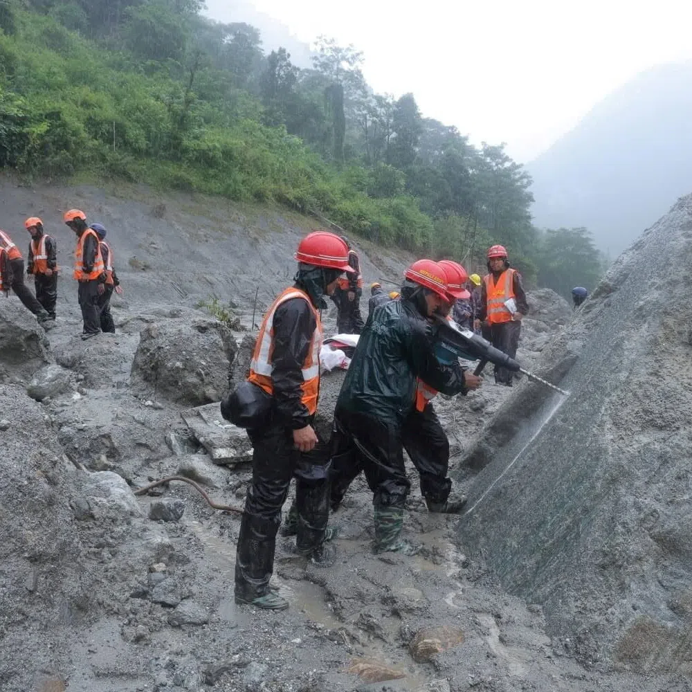 A rescue operation near the tunnel of the Trishuli 3A Hydropower Project in Rasuwa, Nepal, following deadly flash floods and mudslides.