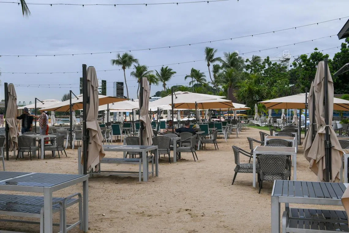Few patrons can be seen at Ola Beach Club on Siloso Beach on June 30, 2024.