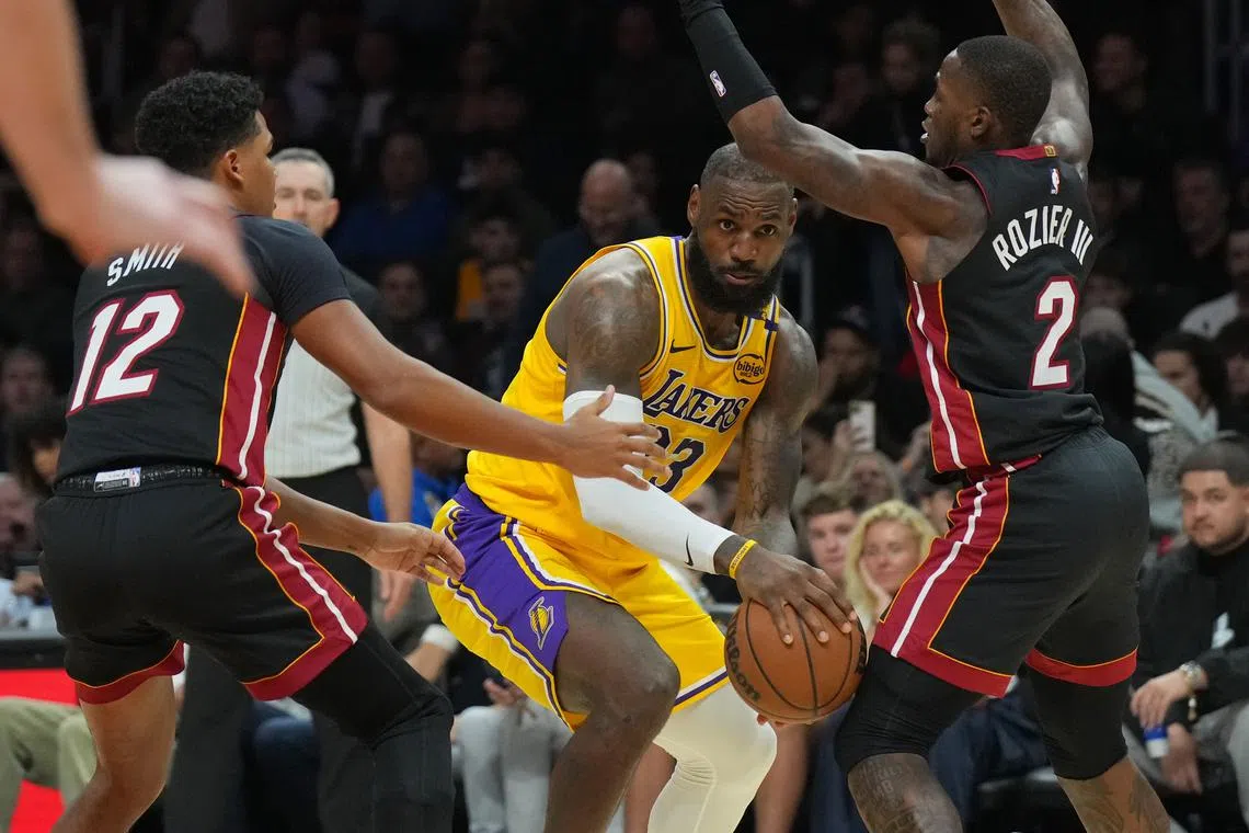Dec 4, 2024; Miami, Florida, USA;  Los Angeles Lakers forward LeBron James (23) looks to pass the ball as Miami Heat guard Terry Rozier (2) defends in the second half at Kaseya Center. Jim Rassol-Imagn Images/File Photo