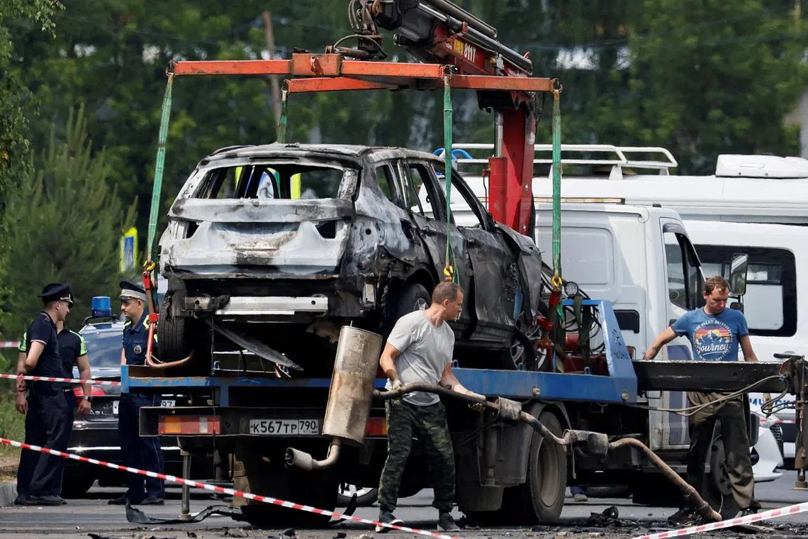 A crane lifts a wrecked car at the scene of a car explosion, which killed the driver, in the city of Balashikha in the Moscow region, Russia, June 9, 2026. REUTERS/Yulia Morozova     TPX IMAGES OF THE DAY