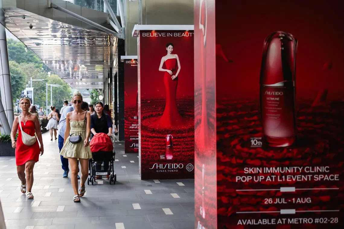 ST20240730_202412000974: Gin Tay/ pixredwhite/
Members of the public walking past Shiseido advertisement posters outside the entrance to Paragon in Orchard Road on July 30, 2024. ST PHOTO: GIN TAY