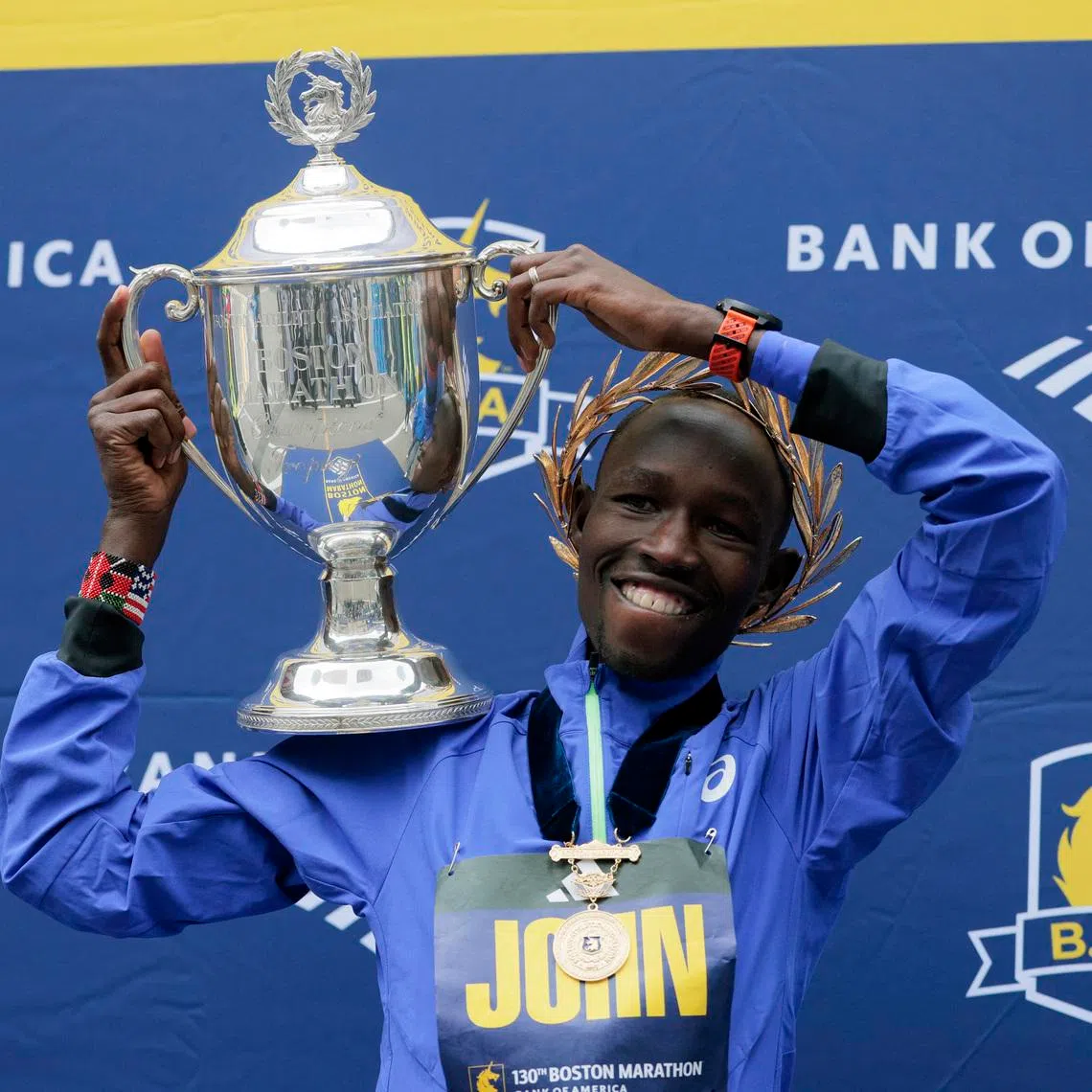 Athletics - Boston Marathon - Boston, Massachusetts, U.S. - April 20, 2026 Kenya's John Korir celebrates with a trophy after winning the men's elite race REUTERS/Brian Snyder