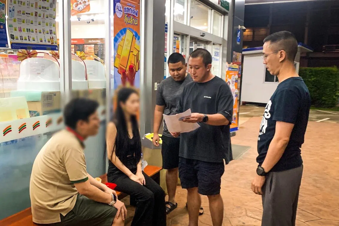 Thai police investigators apprehending members of the Lock Star hybrid scam gang.