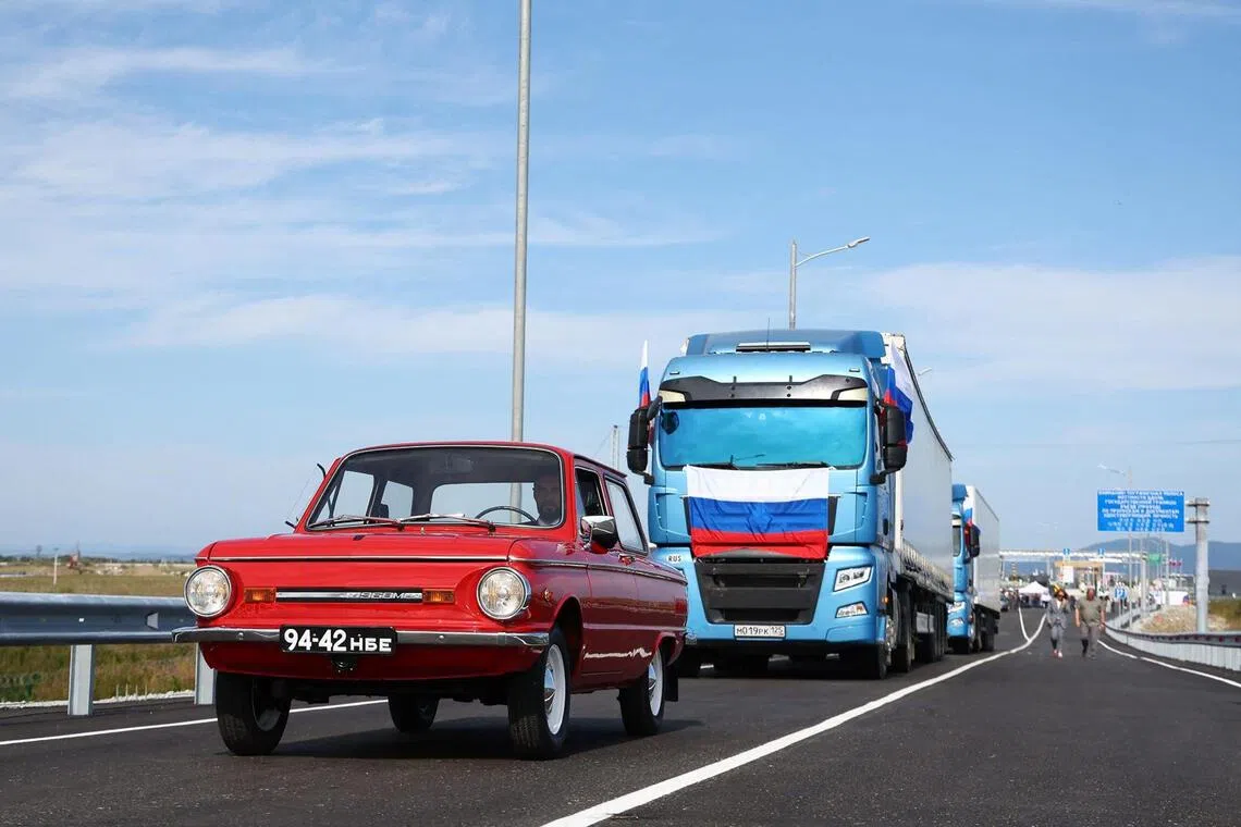 In this handout image released by the Russian Transport Ministry on September 7, 2026, Russian trucks and a Zaporozhets car cross the new Russia-North Korea road bridge over the Tumen River, during the opening ceremony. (Photo by Handout / Russian Transport Ministry / AFP) / RESTRICTED TO EDITORIAL USE - MANDATORY CREDIT "AFP PHOTO / Russian Transport Ministry" - HANDOUT - NO MARKETING NO ADVERTISING CAMPAIGNS - DISTRIBUTED AS A SERVICE TO CLIENTS