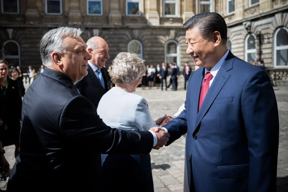 Chinese President Xi Jinping (right) shakes hands with Hungarian Prime Minister Viktor Orban prior to a welcoming ceremony in Buda Castle of Budapest, Hungary.