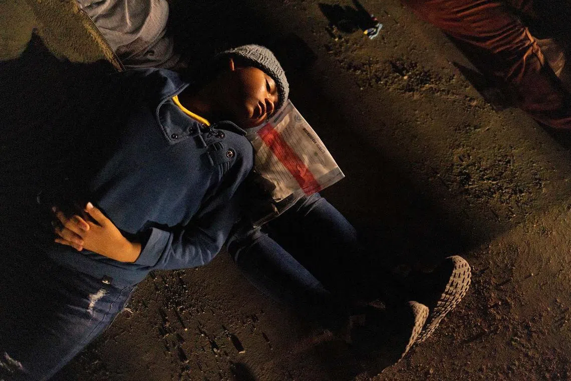 Adeline, a 10 year old migrant from Guatemala, sleeps on her mother's lap as they surrender to border patrol agents after crossing into United States from Mexico in Roma Creek, Texas, U.S., Sept 20.