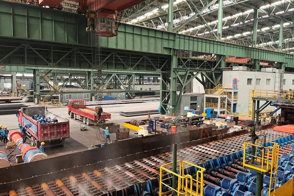 Employees work on the production line at a Baowu Group steel mill in Ezhou, Hubei province, China June 21, 2023.