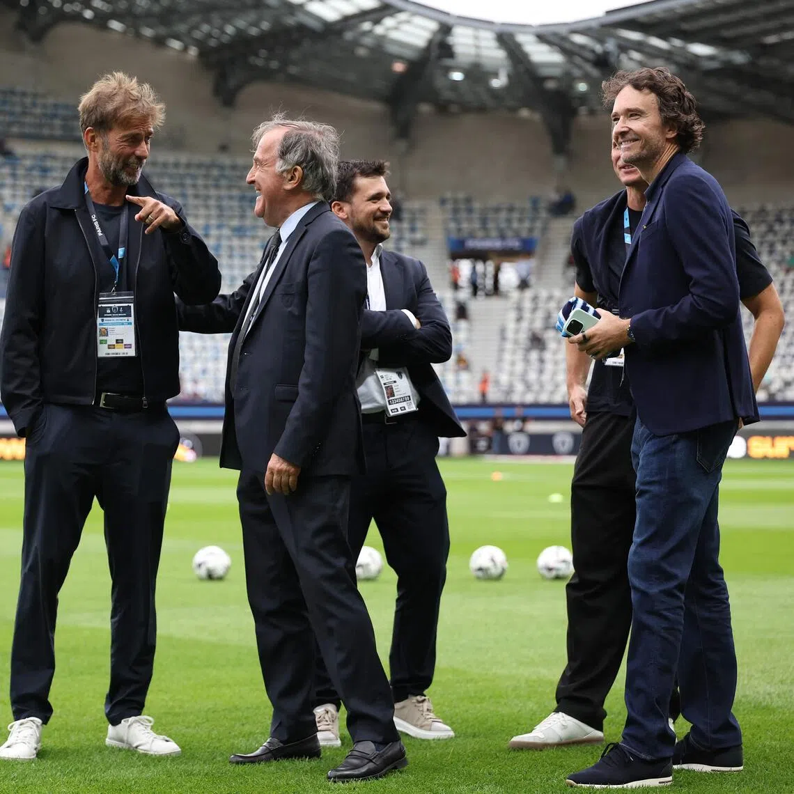 Global head of football at Red Bull Jurgen Klopp speaks with Paris FC's French president Pierre Ferracci.