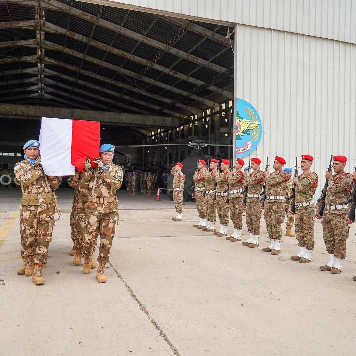 This handout photograph, taken and released by the United Nations Interim Force in Lebanon (UNIFIL), shows comrades carrying the coffin of 31-year-old Indonesian Corporal Rico Pramudia as he is honoured during a ceremony held at the International Airport in the Lebanese capital Beirut on April 26, 2026. The UN peacekeeping force in Lebanon, UNIFIL, announced on April 24, 2026, that an Indonesian blue helmet died in hospital of wounds suffered on March 29 in an attack on his base. "UNIFIL deplores the passing today of Corporal Rico Pramudia, who was critically injured following a projectile explosion in his base in Adchit Al Qusayr on the night of 29 March," the force said in a statement. His death brings to six the number of peacekeepers killed since the start of the most recent war between Israel and Hezbollah on March 2. (Photo by Haidar Fahs / UNIFIL / AFP) / RESTRICTED TO EDITORIAL USE - MANDATORY CREDIT "AFP PHOTO / UNIFIL /HANDOUT / Haidar Fahs" - HANDOUT - NO MARKETING NO ADVERTISING CAMPAIGNS - DISTRIBUTED AS A SERVICE TO CLIENTS