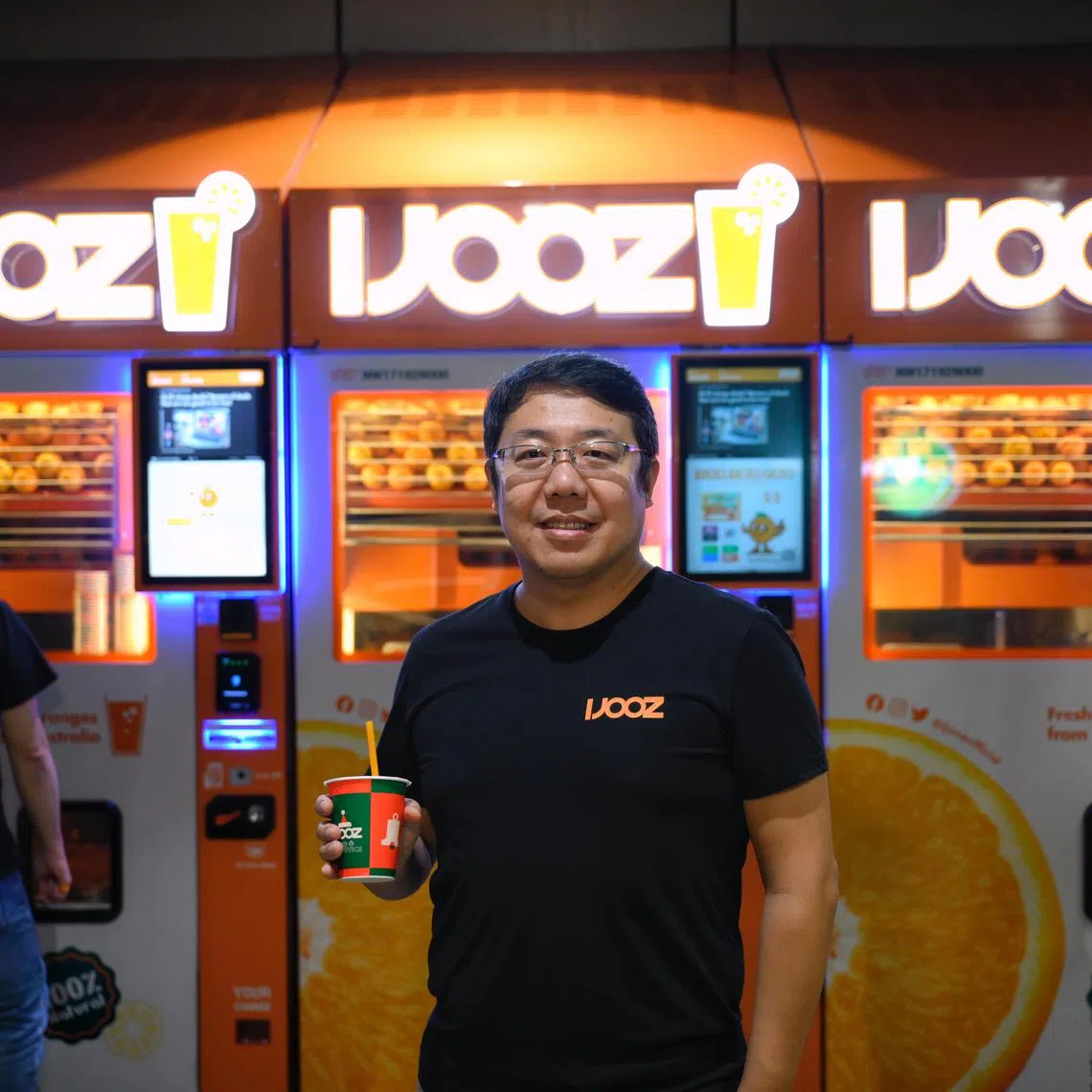 iJooz chief executive Bruce Zhang in front of a row of vending machines at Yishun Bus Interchange. The company aims to install 5,000 machines across Singapore in total. 
