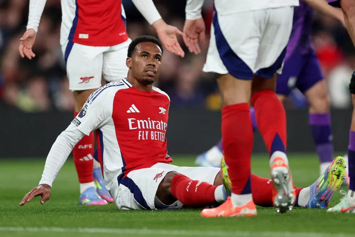FILE PHOTO: Soccer Football - Premier League - Arsenal v Fulham - Emirates Stadium, London, Britain - April 1, 2025 Arsenal's Gabriel Magalhaes reacts after sustaining an injury REUTERS/David Klein/File Photo
