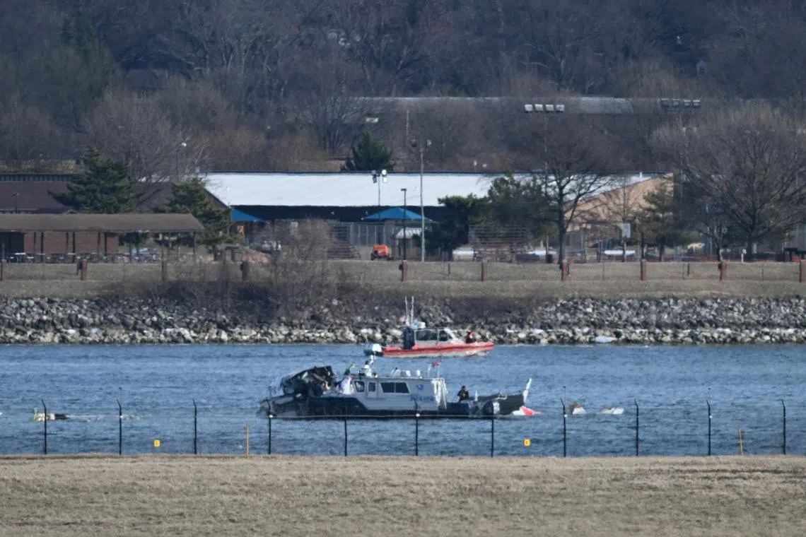 A police boat gathering wreckage on Jan 30 along the Potomac River, after American Airlines flight 5342 collided mid-air with a US Army helicopter.