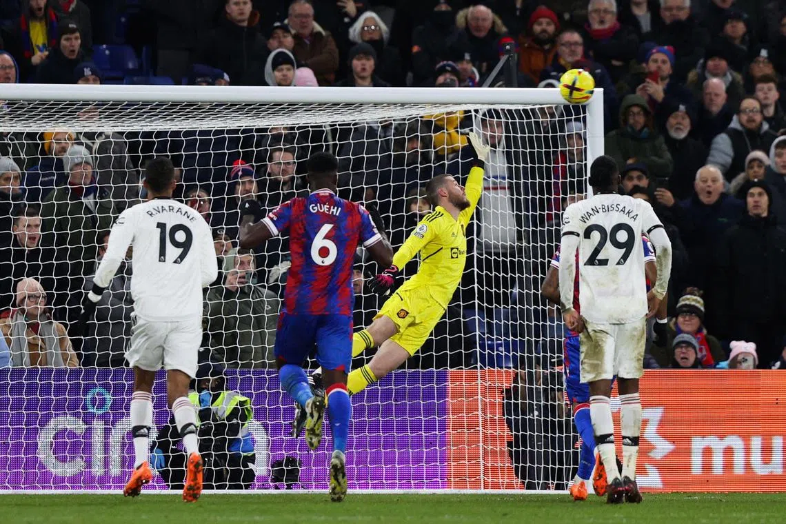 Crystal Palace's French midfielder Michael Olise (unseen) shoots a penalty kick and scores past Manchester United's Spanish goalkeeper David de Gea.