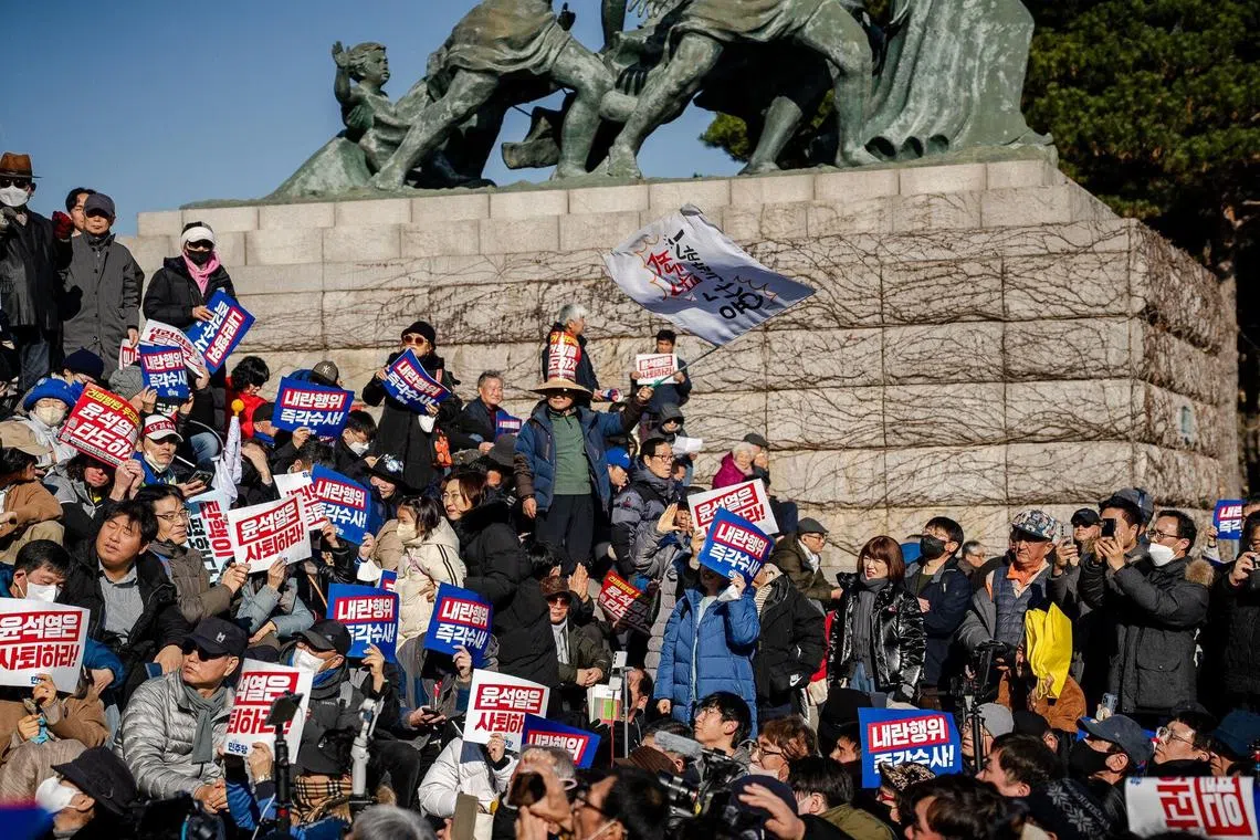 Members and supporters of South Korean opposition parties gather in front of the National Assembly in Seoul, South Korea, on Wednesday, Dec. 4, 2024. South Korea’s opposition called for the impeachment of President Yoon Suk Yeol after he plunged the nation into a political crisis by briefly imposing martial law. Photographer: Tina Hsu/Bloomberg