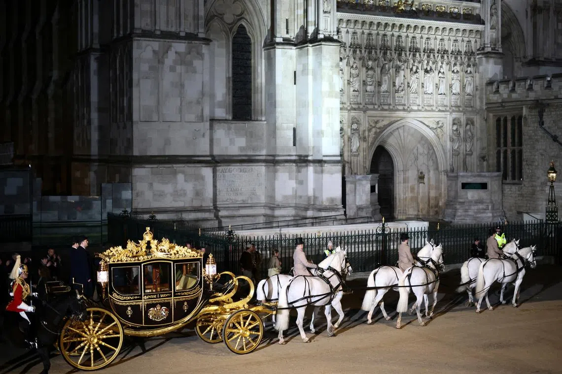 The Diamond Jubilee Coach is ridden alongside members of the military during a full overnight dress rehearsal of the Coronation Ceremony of Britain’s King Charles and Camilla, Queen Consort in London, Britain, May 3, 2023. 