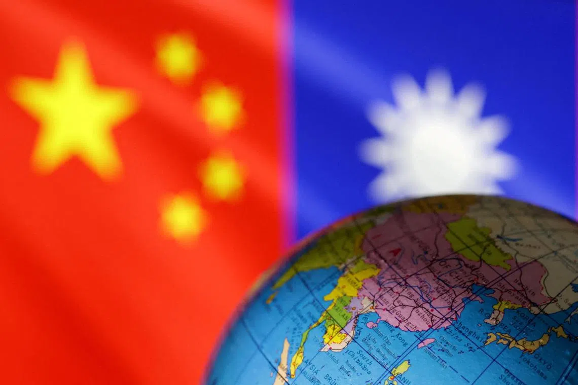 FILE PHOTO: A globe is seen in front of Chinese and Taiwanese flags in this illustration, August 6, 2022. REUTERS/Dado Ruvic/Illustration/File Photo