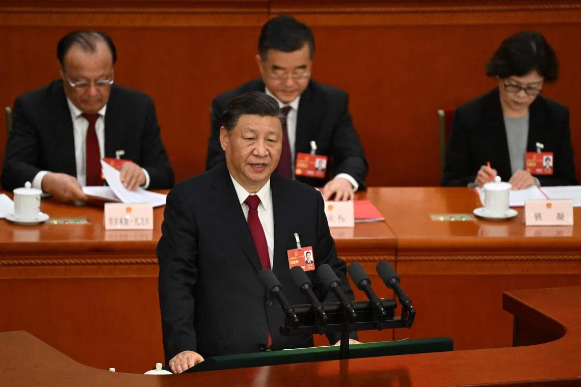 China's President Xi Jinping speaks during the closing session of the National People's Congress in Beijing on March 13, 2023.