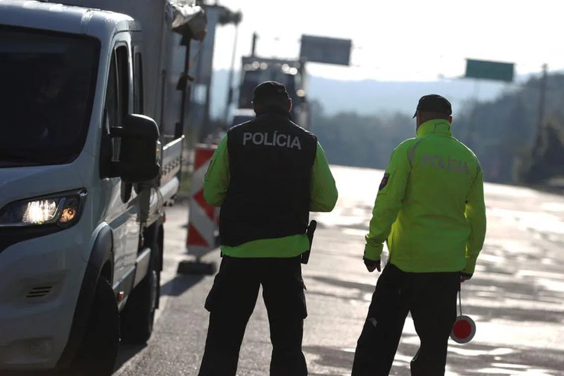 Slovakian police check a vehicle at the Slovakia-Hungary border in Sahy, Slovakia, as Slovakia officially imposed temporary controls on its border with Hungary due to a rising number of illegal migrants coming on the Balkans route, October 5, 2023. REUTERS/Bernadett Szabo