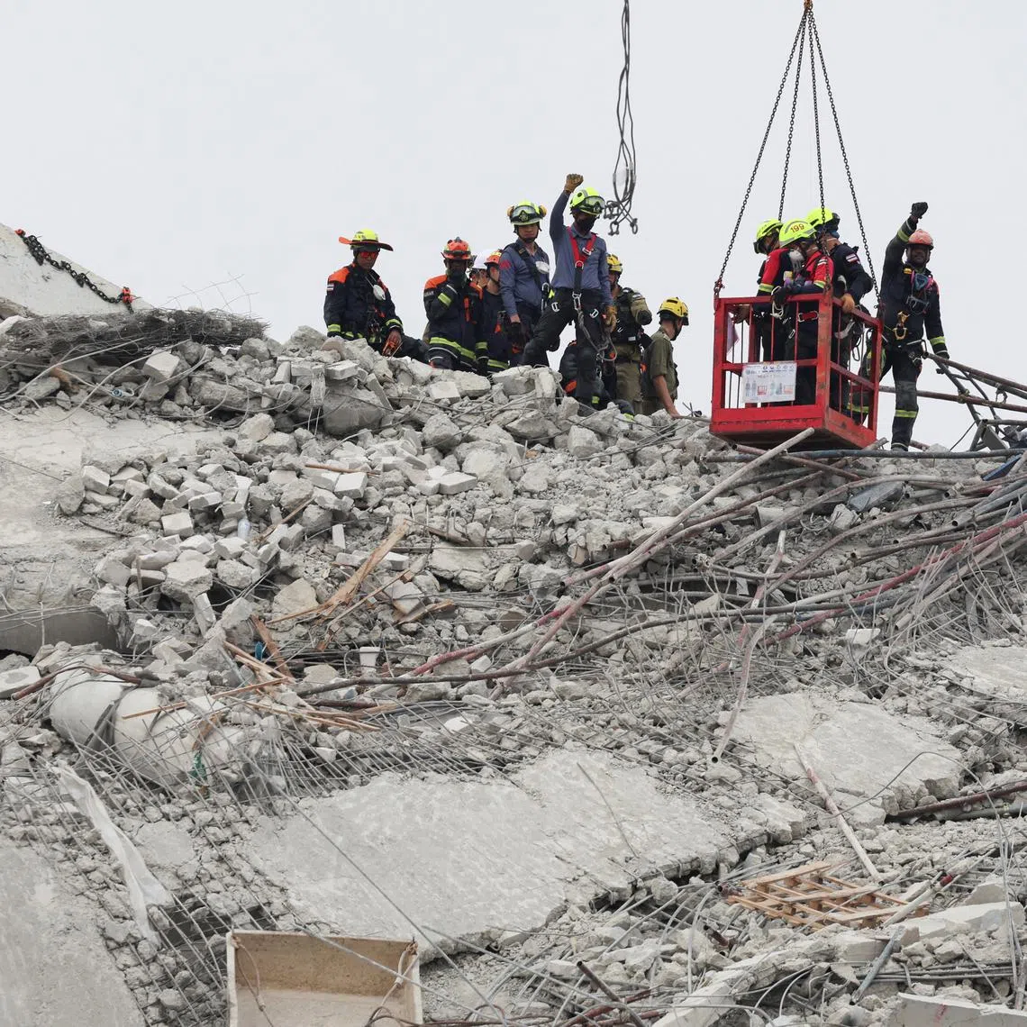 Rescue workers operate at the site of a collapsed building, following a strong earthquake in Bangkok on April 1.