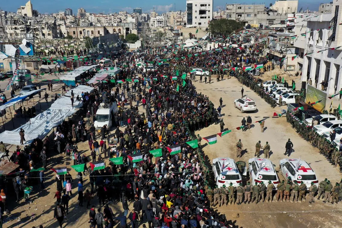A drone view shows Palestinians, Hamas and Islamic Jihad militants gathering near ICRC vehicles on the day of the release of four female Israeli soldier hostages.