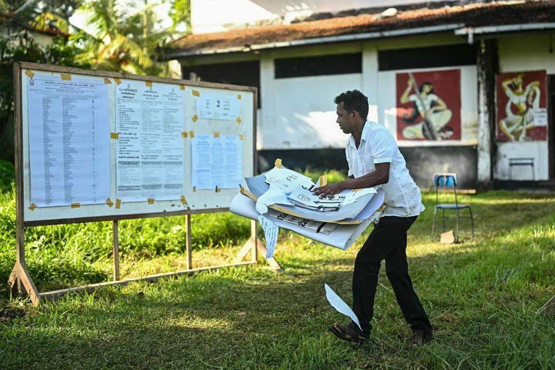 A polling official collects candidate lists after the end of voting in Sri Lanka's presidential election in Galle on September 21, 2024. Cash-strapped Sri Lanka voted for its next president on September 21 in an effective referendum on an unpopular International Monetary Fund austerity plan enacted after the island nation's unprecedented financial crisis. (Photo by IDREES MOHAMMED / AFP)