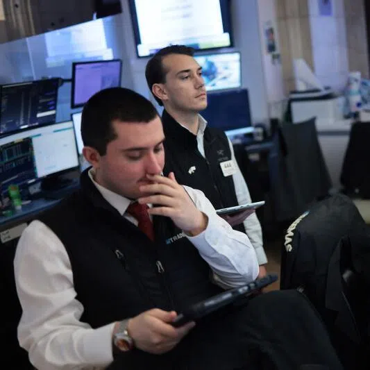 Traders work on the floor of the New York Stock Exchange during morning trading on June 15, 2026 in New York City.