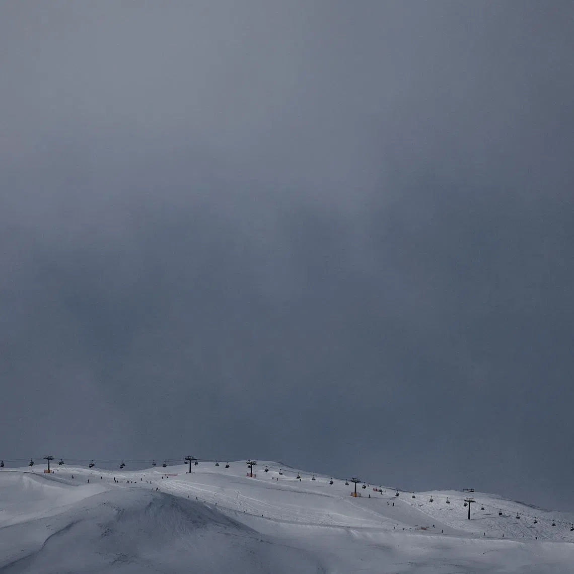 FILE PHOTO: A drone view shows cable cars operating above snow-covered ski slopes, ahead of the 2026 Milan Cortina Olympic games, in Livigno, Italy, January 9, 2026, REUTERS/Yara Nardi   /File Photo