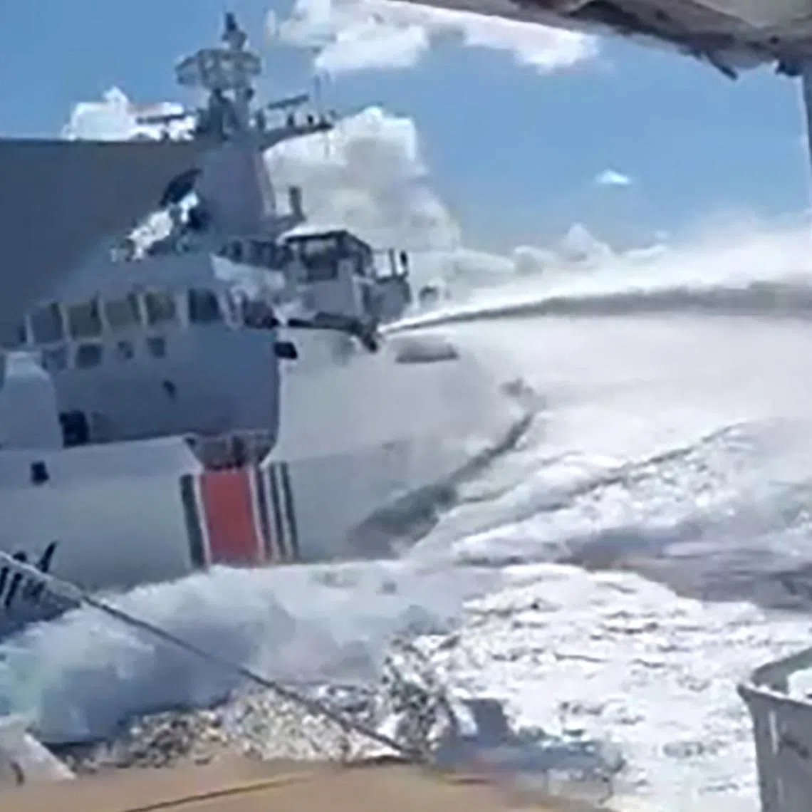 An incident between a Chinese Navy vessel (far left, bow pictured) and a Chinese Coast Guard ship (second from left) as seen from a Philippine boat in the South China Sea on Aug 11.