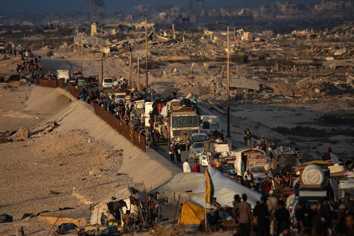 Displaced Palestinians move with their belongings southwards along Al-Rashid Road, west of the Nuseirat refugee camp in the central Gaza Strip, on Sept 24.