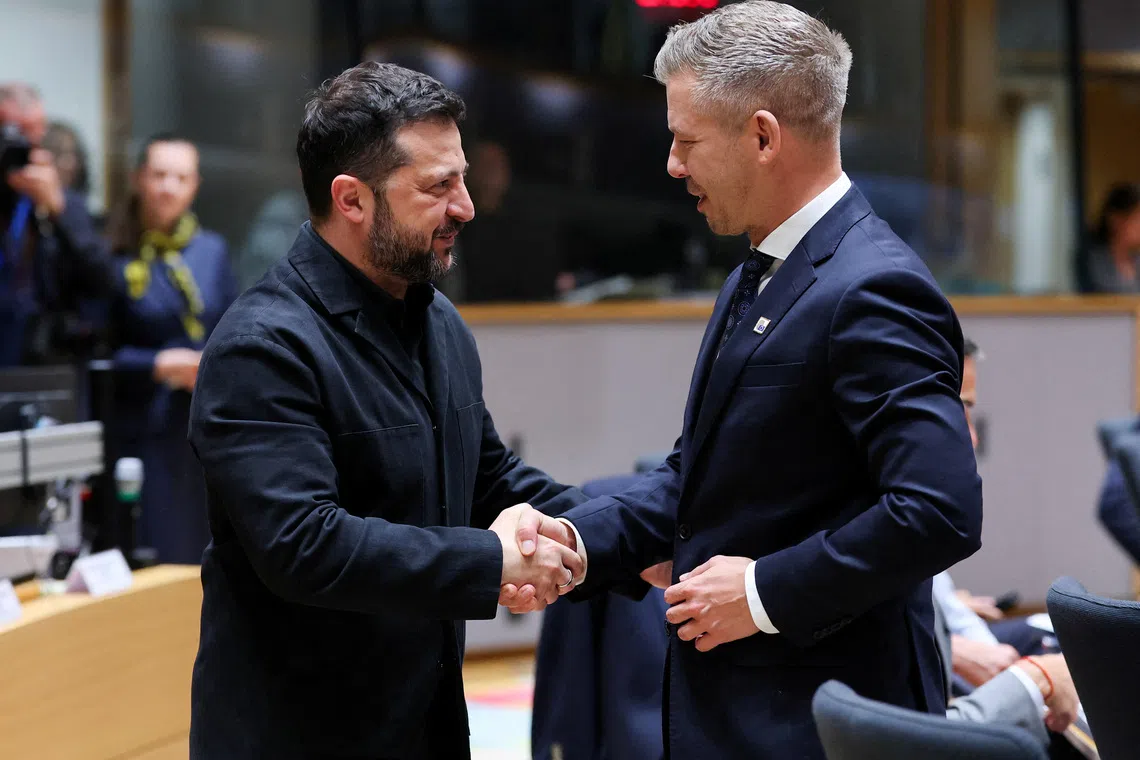Ukraine's President Volodymyr Zelenskiy and Hungary's Prime Minister Peter Magyar greet each other during a European Union leaders summit in Brussels, Belgium October 16, 2026.  REUTERS/Stephanie Lecocq