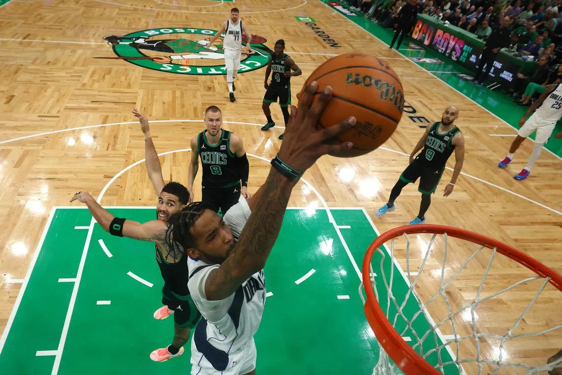 Derrick Jones Jr. of the Dallas Mavericks attempts to dunk the ball past Jayson Tatum of the Boston Celtics during the first half in Game 2 of the NBA Finals.