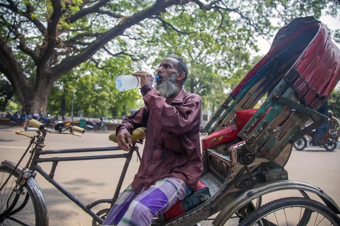 A Bangladeshi rickshaw puller takes a drink during a hot weather day in Dhaka, Bangladesh, on April 17. 
