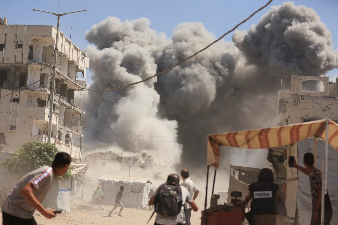 Smoke rises from an evacuated residential building which was housing displaced Palestinians, after it was hit by an Israeli air strike, in Gaza City, September 14, 2025. REUTERS/Dawoud Abu Alkas