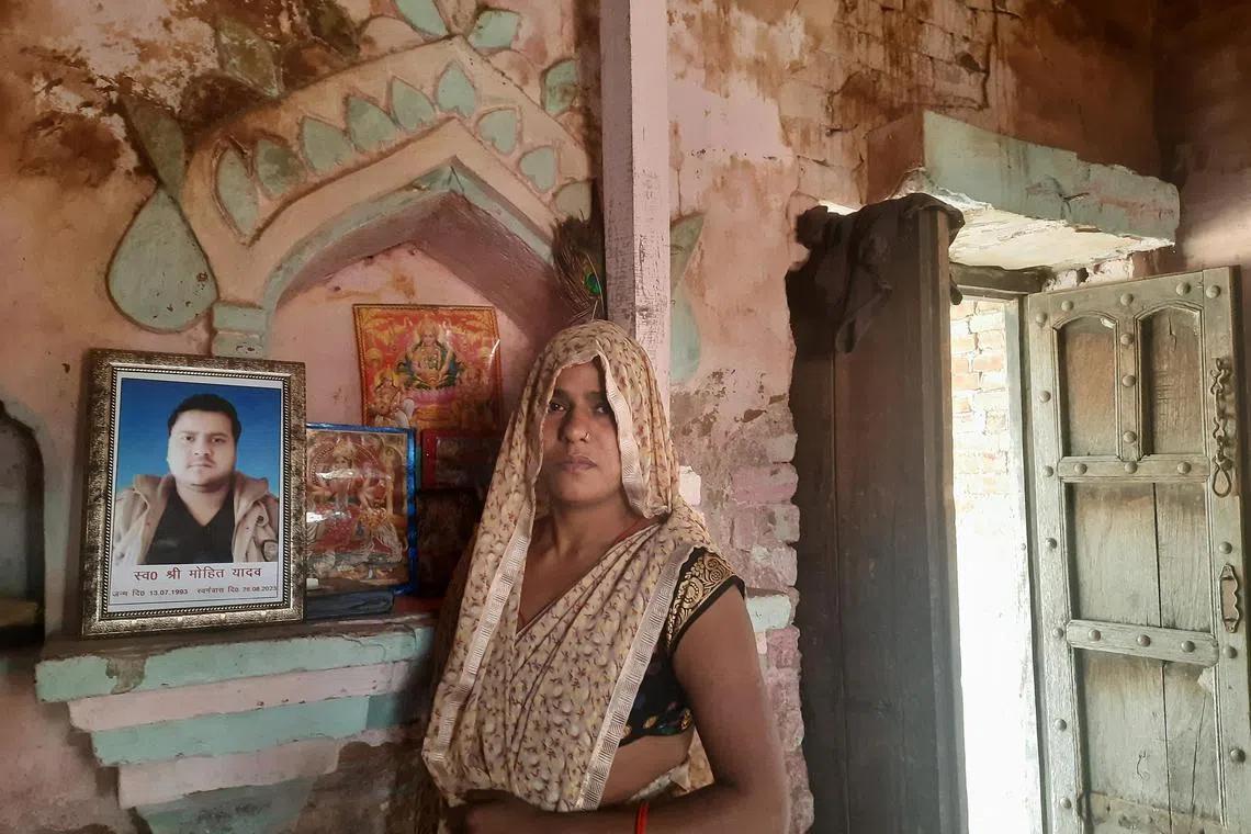 Mr Mohit Yadav's widow Rinki Yadav with a photo of him at their family altar. Mr Yadav killed himself after he was fired for stopping his bus to let Muslim passengers offer prayers.