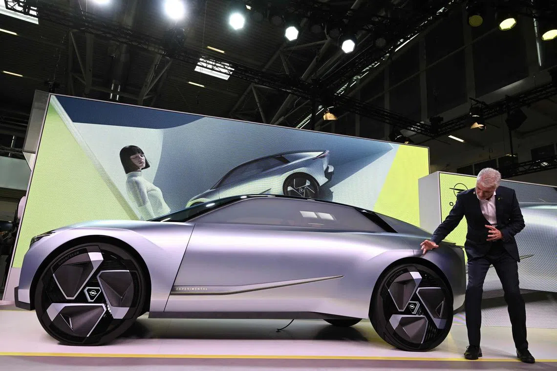 Opel's President for Design Mark Adams stands next to an "Opel experimental" car at the International Motor Show (IAA) at the fairgrounds in Munich, southern Germany, on September 4, 2023. Germany's IAA MOBILITY auto show, one of the world's largest, will be open for the public from September 5 to 10, 2023 and showcase all car-related topics. (Photo by CHRISTOF STACHE / AFP)