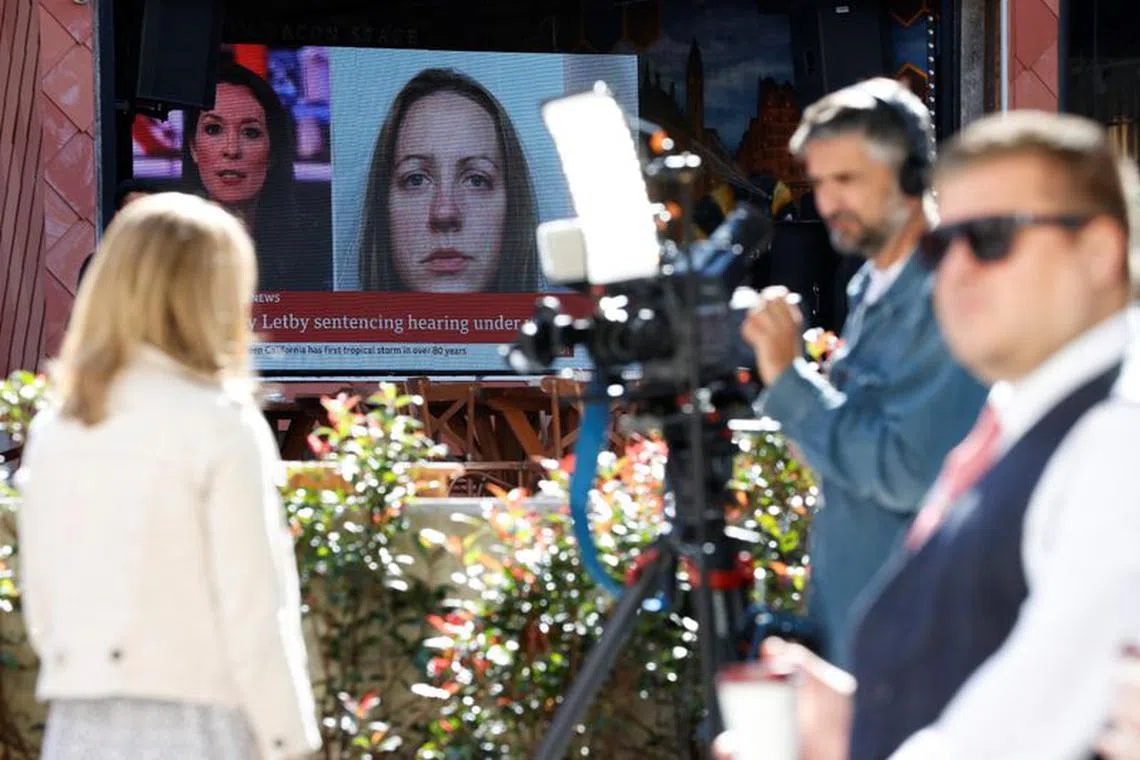 Members of the media work near a large screen showing a picture of convicted hospital nurse Lucy Letby, in Manchester, on Aug 21, 2023.